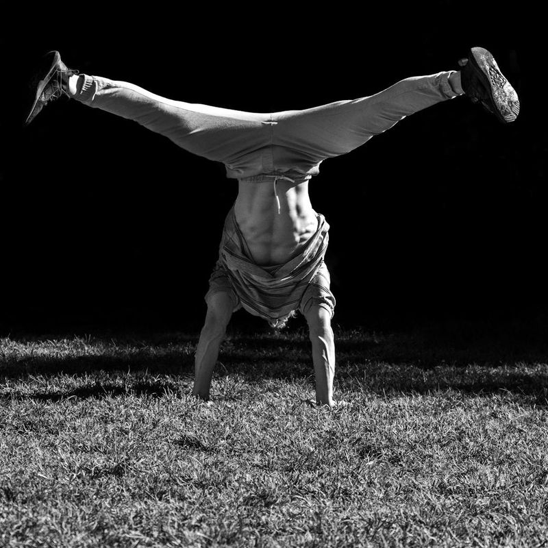 Man in mid-motion during a dynamic bodyweight exercise.
