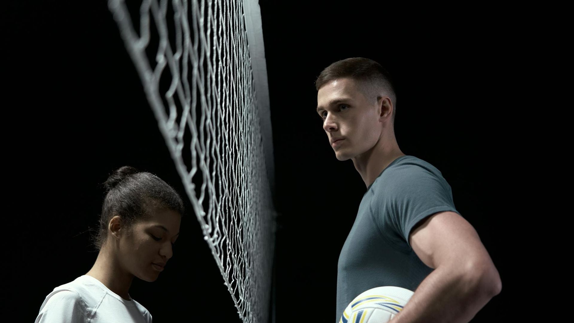 Silhouette of a man in a powerful stance against a dark background.